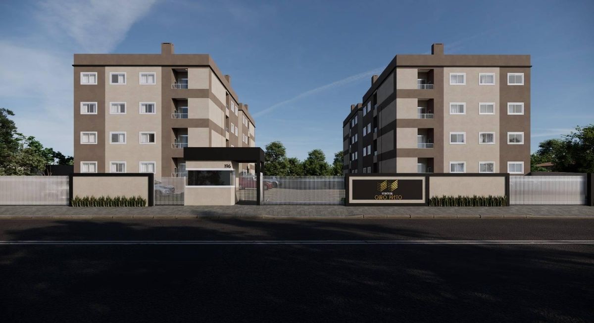 Prédio residencial com duas torres de apartamentos, portaria e cerca.