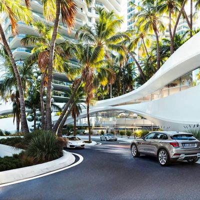 entrada de prédio com plantas e carros na rua, edifício moderno branco